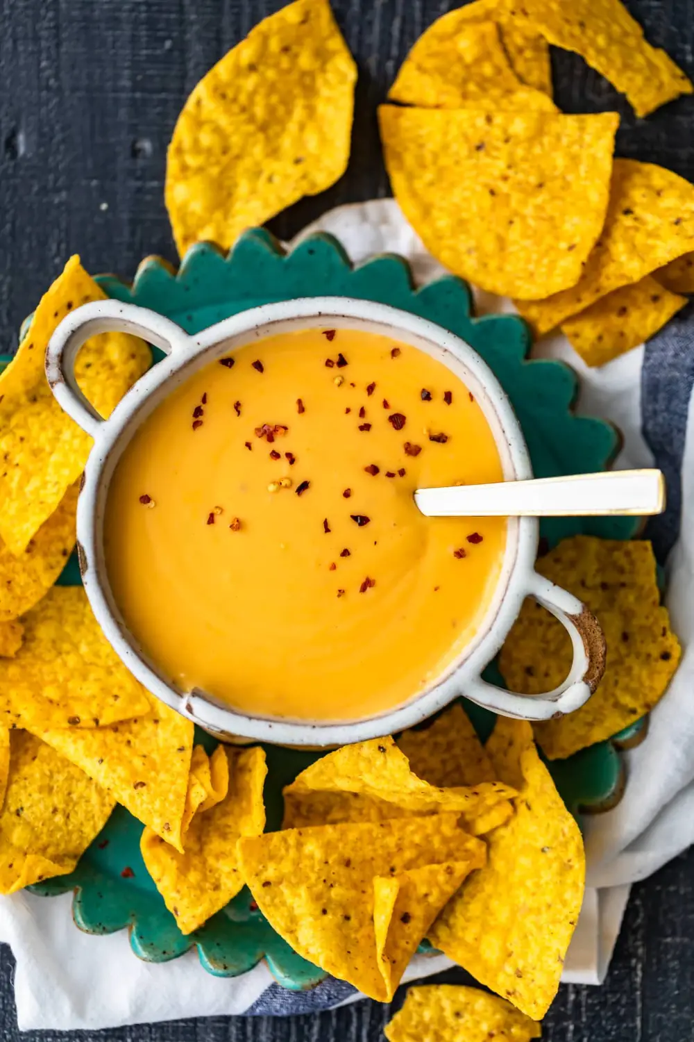 homemade nacho cheese sauce in a bowl, surrounded by ...