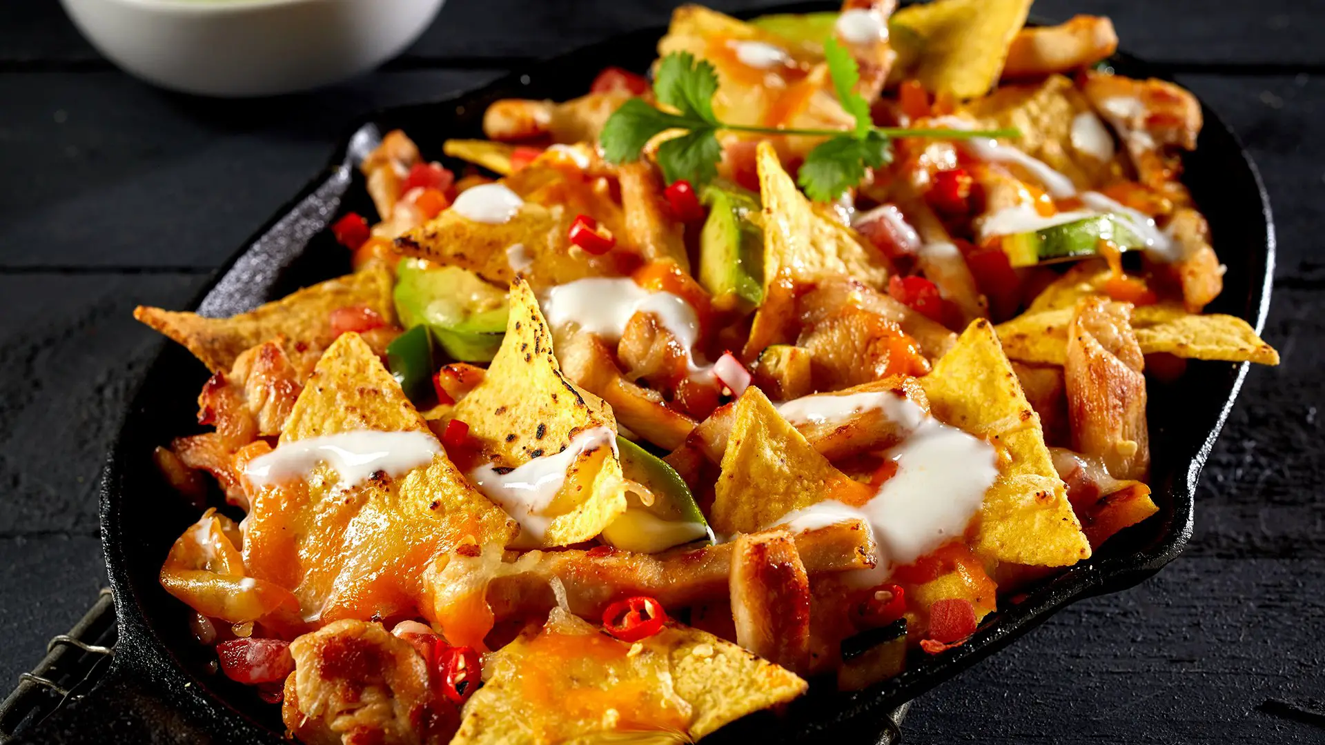 Taco nachos with diced tomatoes and shredded cheese